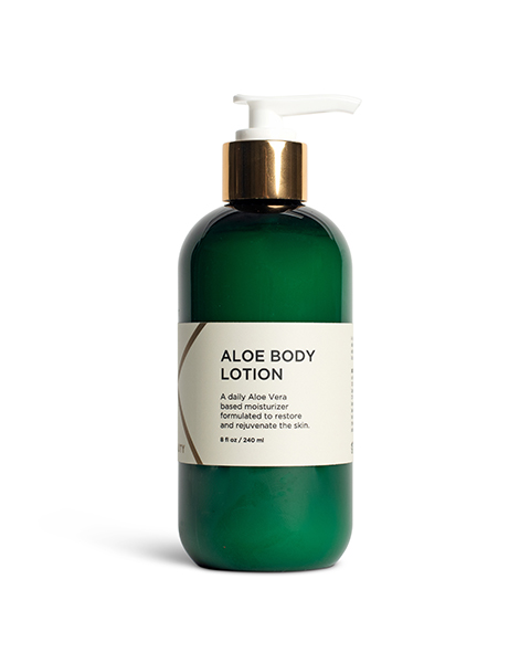A green bottle of Aloe Body Lotion with a white pump dispenser. The label on the bottle is white with black and gold text, indicating that it is a daily Aloe Vera-based moisturizer formulated to restore and rejuvenate the skin. The bottle contains 8 oz / 240 ml.