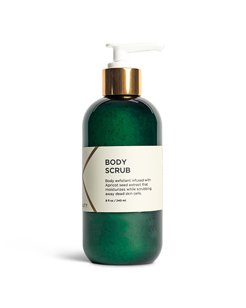 A green plastic bottle with a white pump dispenser, containing body scrub. The bottle has a gold-colored collar and a beige label that reads "Body Scrub." The label also mentions apricot seeds for exfoliation and a capacity of 8 oz (240 ml).