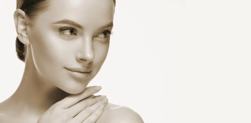 Woman with smooth skin and contemplative expression.