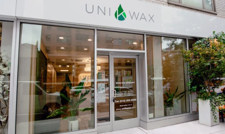 Entrance of Uni K Wax store with plants outside.