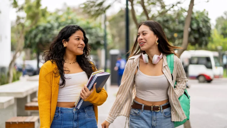 Two friends walking and talking outdoors