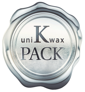 A silver wax seal with an embossed design that reads "uniKwax PACK" in bold black letters. The circular seal has a shiny, beveled edge and a smooth, reflective surface, giving it a polished and official appearance.